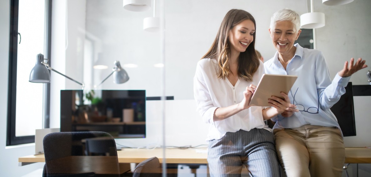 two office lady discuss on laptop by desk 274711326